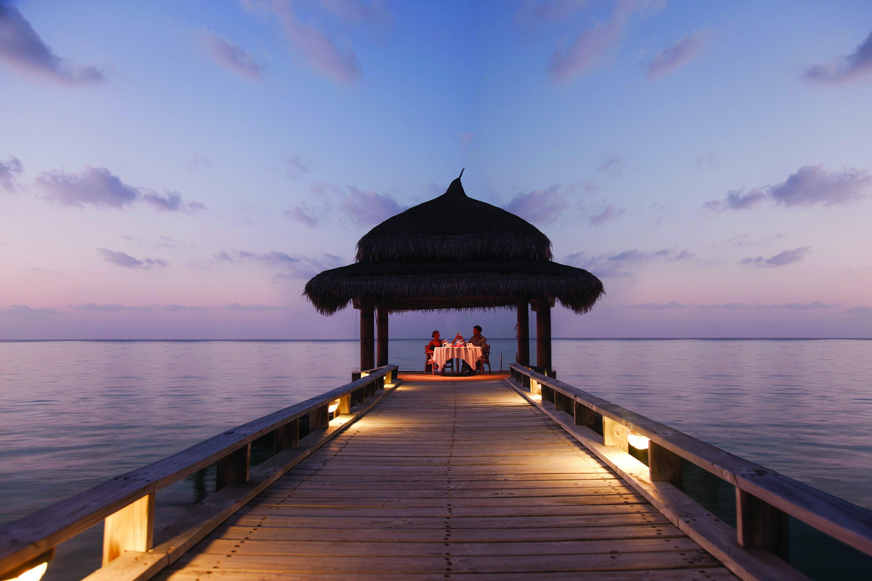 Couple eating on tropical dock